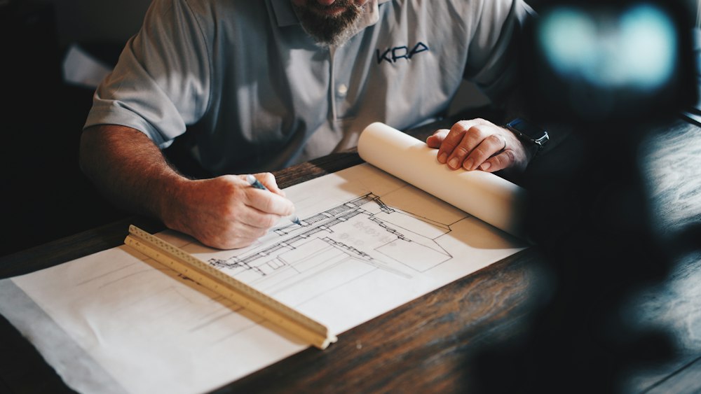 Archetype architects reviewing blueprints in Kinshasa studio